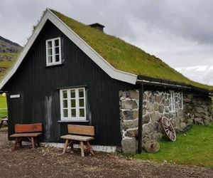 Turf house in Saksun with panoramic view Faroe Islands Denmark